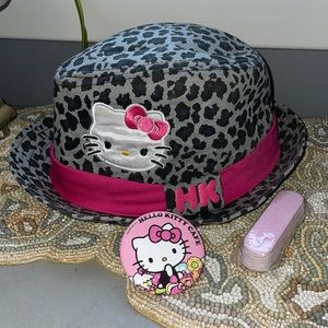 Hello Kitty fedora type hat HK Cafe button and a pack of pink files.